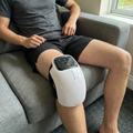 Knee massager worn on the couch
